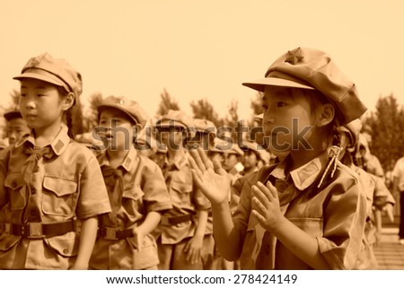 LUANNAN COUNTY - JULY 16: The Elementary student dressed in blue military uniform, solemnly swear, on July 16, 2012, luannan county, Hebei province, China