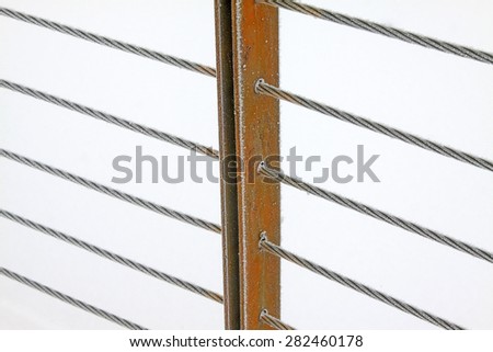 Wire rope and metal pillar in the frost and snow