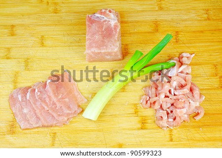 lean meat, onion and garlic on the chopping board