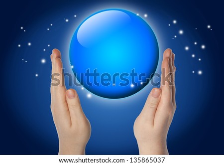 blue sphere or globe in your hands on blue background