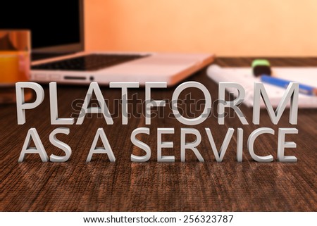 Platform as a Service - letters on wooden desk with laptop computer and a notebook. 3d render illustration.