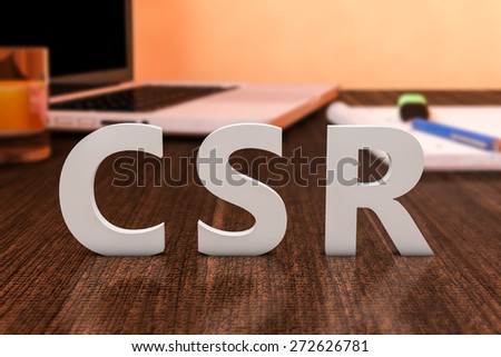 CSR - Corporate Social Responsibility - letters on wooden desk with laptop computer and a notebook. 3d render illustration.