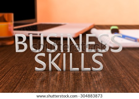 Business Skills - letters on wooden desk with laptop computer and a notebook. 3d render illustration.