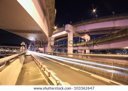 A view to the top of the modern express way at night in a modern city