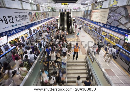 TAIPEI, TAIWAN - JULY 1: Passengers getting on and off on the platform of Taipe MRTon June 1, 2014 in Taipei. The Taipei MRT Subway is one of the best way to go ground and commute in Taipei city