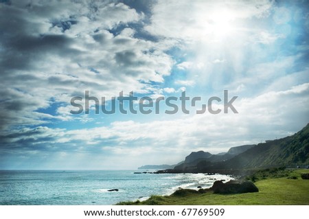 Sun over the sea by the mountain