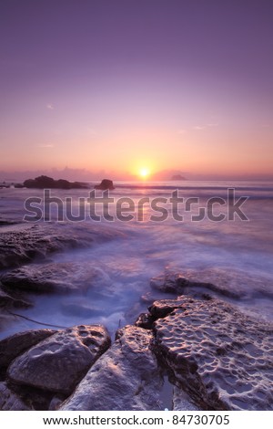 beautiful sun rise by the rocky coast with the sun
