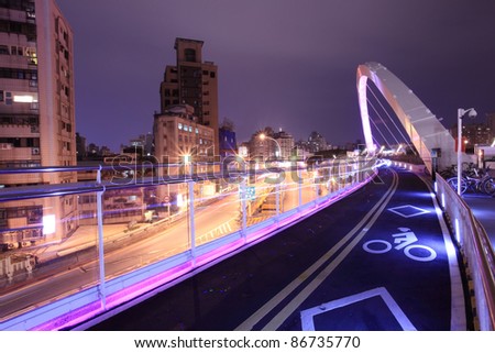 a bridge for the bike in the modern city at night