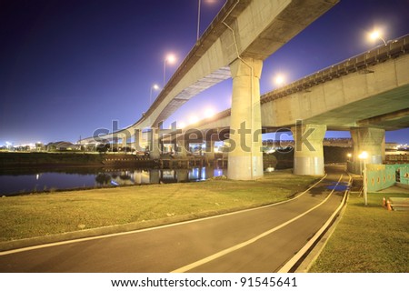 a bike road under the bridge of the express way in a modern city