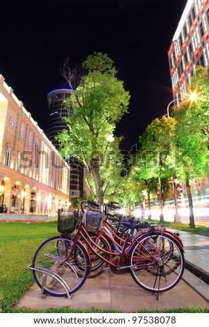 close up shot of Bicycles by the bicycle parking space in a modern city at night