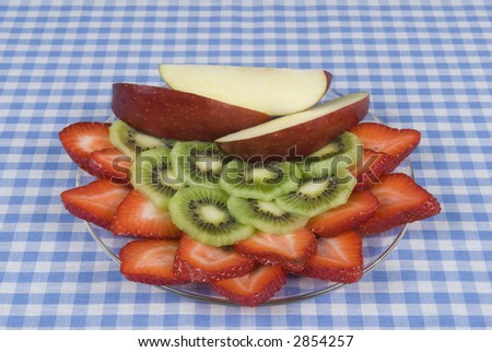 mixed fruit dish on a blue and white checkerboard cloth