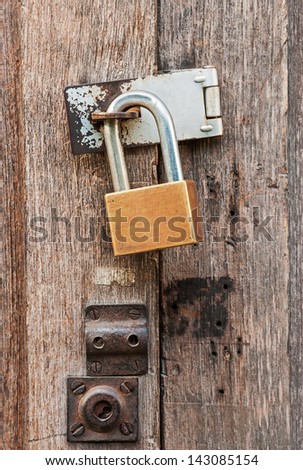 The padlock locking the old wooden door