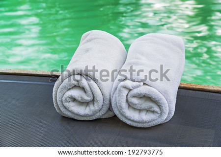 White towels on pool chairs at swimming pool