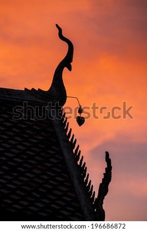 Silhouette of gable apex on the roof of Thailand temple in sunset