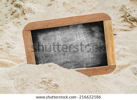 Blank chalkboard on the sand