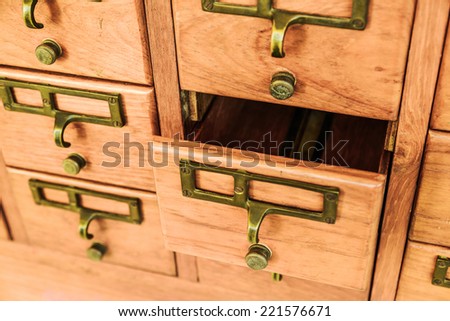 Old wooden drawers with one opened.