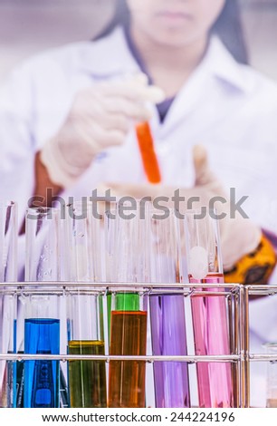 Young attractive female scientist mixing chemicals