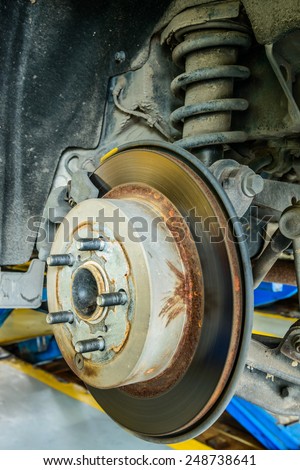 Close up of disk brake on car in process of damaged.- Brake job