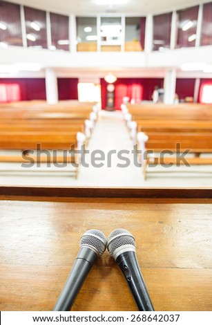 Closeup microphone in empty church with empty pews