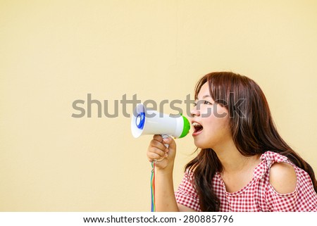 Young asian woman holding megaphone.