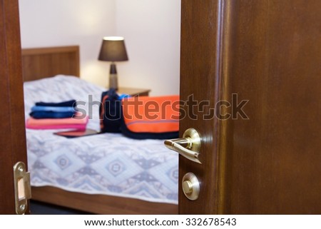 Half-open  door with a view of  bedroom
