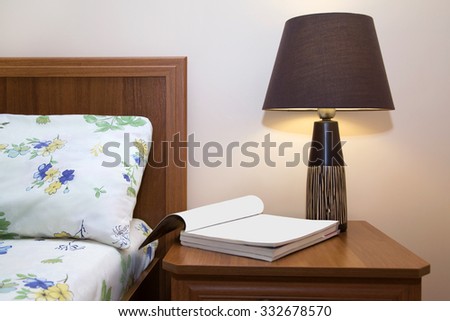 Bedside table near the bed in the bedroom  evening