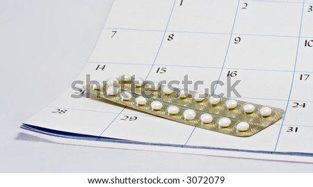 Birth control pills on a calendar