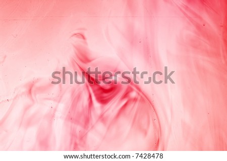 Red fluid behind a dirty glass