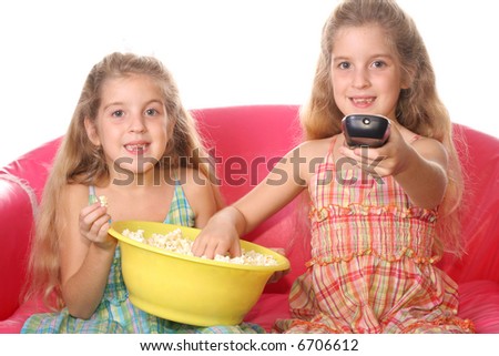 stock photo : happy children watching a movie eating popcorn