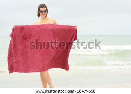 naked woman covering up with towel