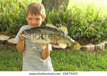 cute little boy showing off his bass