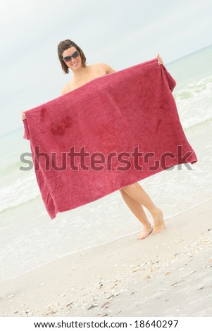 naked woman covering up with towel angle