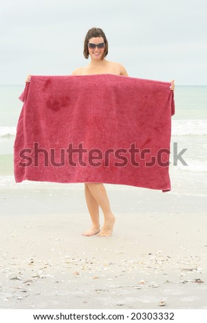 naked woman covering up with towel vertical