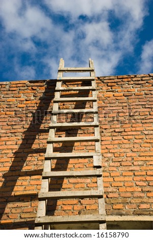 wooden ladder on orange wall