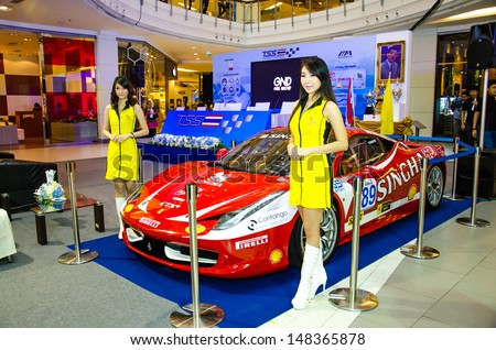 BANGKOK - JULY 31 :  Unidentified model with car on Press conference of Flat race cars on display at Thailand Super Series 2013 Course 3 and 4 on July 31, 2013 in Bangkok, Thailand