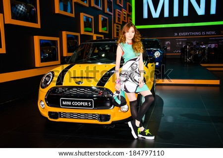 BANGKOK - MARCH 25: Unidentified model with Mini Cooper S car on display at The 35th Bangkok International Motor Show on March 25, 2014 in Bangkok, Thailand.
