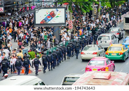BANGKOK - MAY 24: Riot police stand guard on Major Cineplex Ratchayothin Bangkok during a violent anti-Military coup on May 24, 2014 in Bangkok, Thailand.