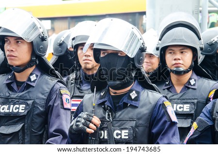 BANGKOK - MAY 24: Riot police stand guard on Major Cineplex Ratchayothin Bangkok during a violent anti-Military coup on May 24, 2014 in Bangkok, Thailand.