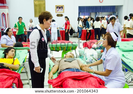 SINGBURI - JUNE 12 : Unidentified blood donors in World Blood Day 2014 at Sing Buri Red Cross office on June 12, 2014 in Singburi, Thailand.