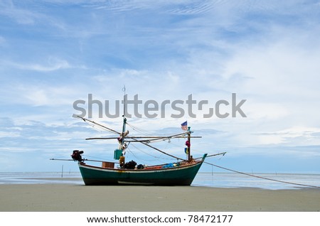 Coastal fishing boat waiting at the water to catch fish.