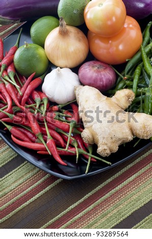 Fresh vegetables for cooking on black plate and nice met