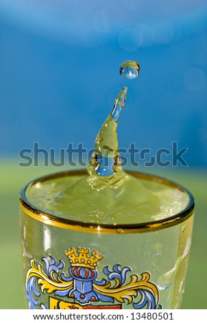 Vodka splashing out of a shot glass