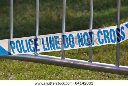 Police line do not cross barrier blocking off crime or accident  scene