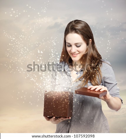 Happy Young Woman Opening a Gift Box