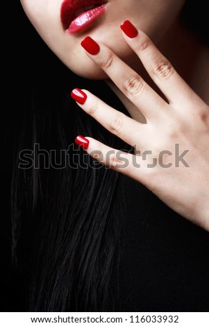 Close up of woman red nails, lips and long black hair