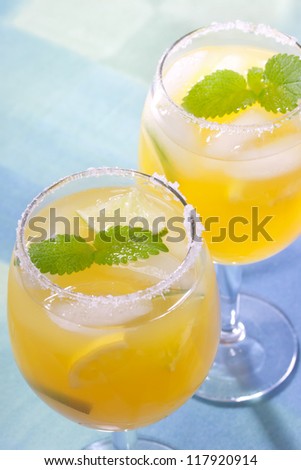 Two fresh margaritas with salt and crushed ice