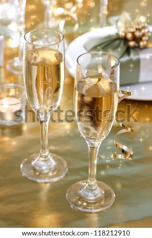 Champagne glasses on the dinner table with gift boxes