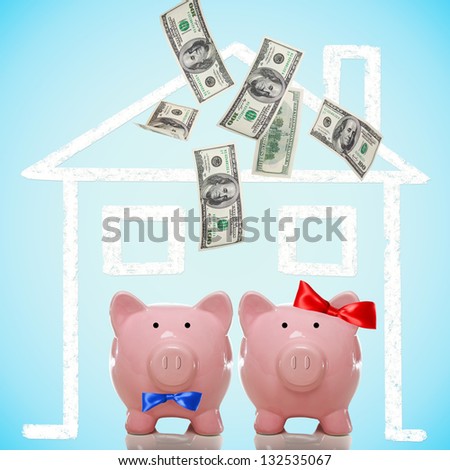 Piggy bank couple buying or dreaming of a new home with flying money
