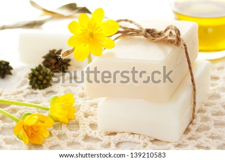 Bars of soap with yellow flowers and oil