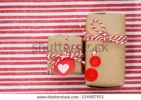 Handmade craft gift boxes on striped cloth